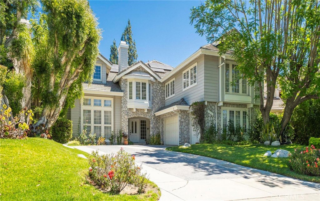 Located in the prestigious guard-gated Ridgegate community of Porter Ranch, this expansive residence offers the perfect blend of luxury, functionality, and privacy. Boasting 5 bedrooms and 7 bathrooms, this home is designed for both elegant entertaining and everyday comfort. Step into the grand foyer, where soaring ceilings and polished marble floors create a striking first impression. To the left and right, you’ll find a formal dining room—ideal for hosting refined gatherings—and a gracious formal living room featuring dramatic ceilings and a stately fireplace. A sweeping staircase leads you upstairs to four generously sized bedrooms, including a remarkable primary suite that overlooks the backyard. This serene retreat offers a private fireplace, dual bathrooms, and a spacious walk-in closet with custom built-ins. At the heart of the home, the stunning center-island kitchen is appointed with granite countertops, recessed lighting, a Sub-Zero refrigerator, abundant cabinetry, and a charming breakfast nook perfect for casual dining. A private guest suite with its own en-suite bath is thoughtfully situated near the laundry area, offering both comfort and convenience. Throughout most of the home, modern hardwood flooring flows seamlessly, enhancing the warm and inviting ambiance. Don’t miss this rare opportunity to live in one of Porter Ranch’s most sought-after gated communities—where elegance, security, and lifestyle meet.