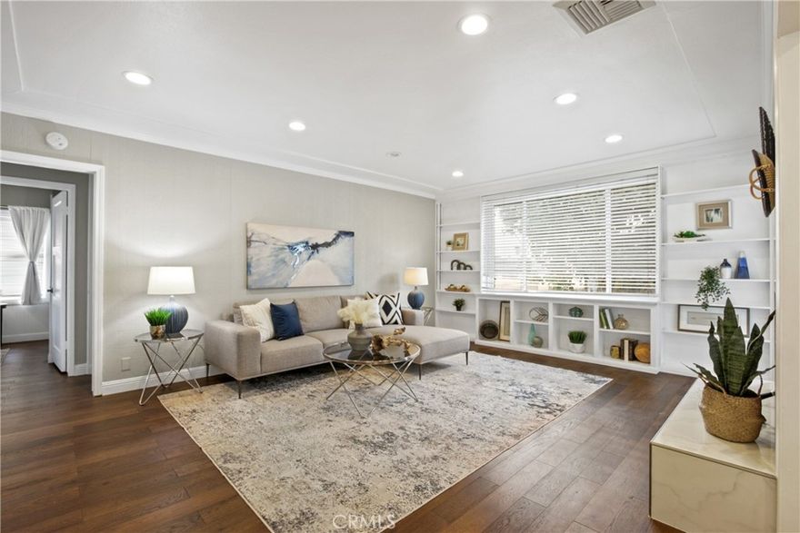 Welcome to this beautifully updated 3-bedroom, 2-bath home located in the Artcraft Manor area, offering 2,052 sq. ft. of comfortable living space on a desirable corner lot, plus a permitted 350 sq. ft. workshop. Step inside to discover stunning hardwood floors, abundant natural light from skylights, and a spacious open layout that flows seamlessly throughout. The expansive primary suite is a true retreat, featuring a cozy fireplace and plenty of room to unwind. The upgraded kitchen boasts quartz countertops, a stylish backsplash, and modern finishes, while both bathrooms have been tastefully remodeled. Additional highlights include newer dual-pane windows, fresh interior paint, central A/C and heating, copper plumbing, and updated gutters for peace of mind. Enjoy outdoor living in the large backyard with a deck, perfect for entertaining. A rare bonus is the attached workshop connected to the two-car garage, ideal for hobbies, a home office, or even conversion into an ADU.  Located just steps from Stearns Park,  great restaurants, and public transportation, this home also offers quick access to Cal State Long Beach, top-rated schools, shopping centers, Long Beach Airport, and the city’s beautiful beaches. This home truly has it all, comfort, upgrades, and an unbeatable location. A must-see!