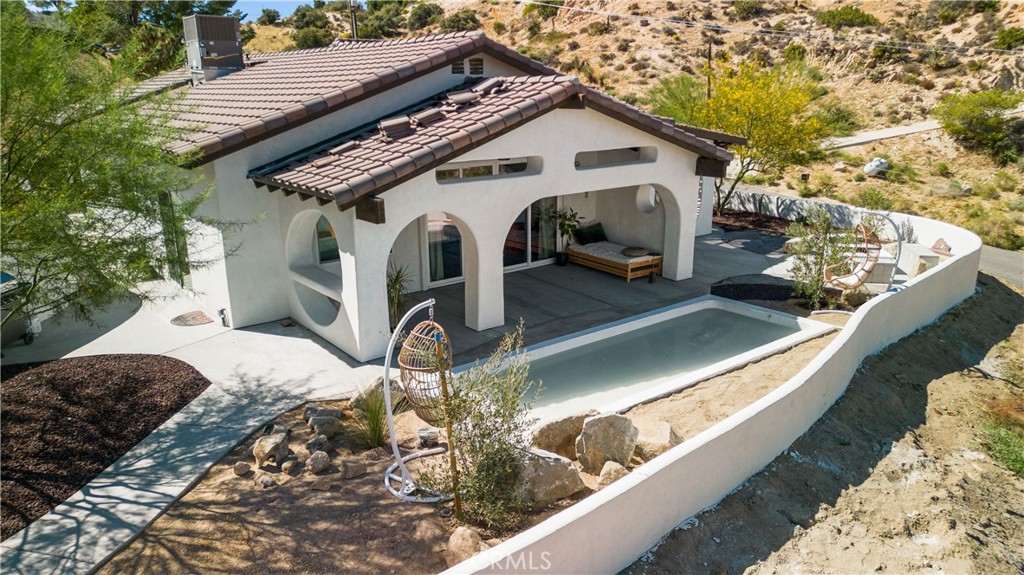 Location, Location, Location! Welcome to this beautiful custom built 4 bedroom 2 bath home in the very highly desired area of Yucca Valley only minutes from the downtown but the feel of living in the rural desert. This home was built perfectly on a hillside with a back yard that is protected by a beautiful rolling hill. This has been 2nd home for the current seller and a very successful Airbnb. The home is fully upgraded with stainless steel appliances with a kitchen that is designed perfectly for cooking and entertaining. The light and bright open floor plan has views from every room making each day feel inspired. The land offers the tranquility that you are looking for in the sought-after Desert. Huge 3 car garage and modern features throughout this home.
