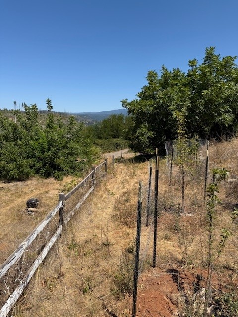 Beautiful 22,651 square foot lot that tapers down hill with the top of the property over looking the water and the mountain range. This hidden gem boasted a 3/2 1,888 square foot home that sat behind the historical Depot placement. PG&E is working diligently on placing all the lines underground and repaving the entrance on Glover Lane. The lot is in a great placement for being close to everything. A few moments to down town Magalia and right down the hill to Paradise. All this property needs is for someone to come in and make it home.