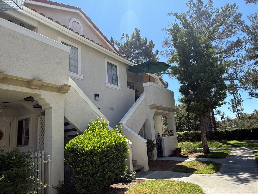 Beautiful and cozy upper-level end unit with private patio. Open living room with high ceiling and adjacent dining area. The remodeled kitchen boasts granite countertops, new cabinets, shelves and appliances. Nicely redone bathroom with an oversized shower. Primary bedroom with high ceiling and good size closet. There are more upgrades including new modern laminate flooring and fresh custom paint. Unit has one assigned carport parking and one parking permit. Access to 4 community pools, tennis courts, sport courts, parks and trails and the beach club lagoon. Refrigerator and washer/ dryer included.