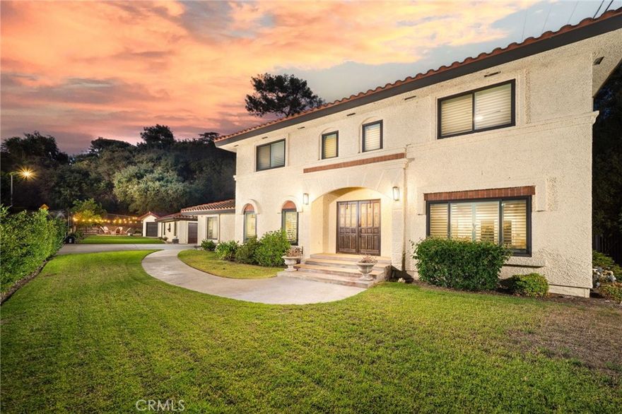 Welcome to this beautifully remodeled gated estate nestled in the heart of North Glendora, just a short walk from award-winning schools. Situated on a generous 14,650 SF flat lot, this exceptional home offers 2,709 SF of updated living space designed for privacy, comfort, and modern living.

Step through the gated driveway and follow the charming walkway to the inviting front porch with double door entry, opening into a formal entryway with soaring ceilings and elegant marble and wood inlay flooring. The formal living room features a cozy fireplace and abundant natural light, flowing seamlessly into the stunning remodeled kitchen, a true chef’s delight with new white cabinetry, large center island, sleek quartz countertops, designer tile backsplash, premium stainless steel appliances including a Jenn Air gas range, walk-in pantry, breakfast nook with slider access to the backyard.

Entertain in style in the formal dining room with a charming bay window and convenient garage access. A private family room offers built-in bookshelves and a quiet retreat. The downstairs powder room has been tastefully updated for guests. Upstairs, the private primary suite is a luxurious haven, complete with a fireplace, dual walk-in closets, and a spa-like ensuite bathroom featuring a freestanding soaking tub, oversized shower, and dual vanities with quartz countertops. Two additional spacious bedrooms share a fully remodeled hall bathroom with a large walk-in shower and updated vanity. Recent Upgrades include, remodeled kitchen and bathrooms, hardwood flooring throughout, new heating and air conditioning, new electrical panel, dual-pane windows and slider, recessed lighting & plantation shutters, water softener and purification system, fresh interior paint. The property offers ample gated parking and two 2- car garages, one attached 2-car garage with laundry and direct access, and a detached 2-car garage with a private office space with split A/C, both garages are fully remodeled with epoxy flooring, new door/openers, built-in storage, and lighting. (Potential ADU conversion opportunity!)

Enjoy the private backyard oasis with covered patio with ceiling fans and lighting, spacious lawn, fire pit, large storage shed, and fruit trees.

Located in the highly desirable Glendora Unified School District, this turnkey property combines timeless elegance, thoughtful upgrades, and a location that’s second to none.