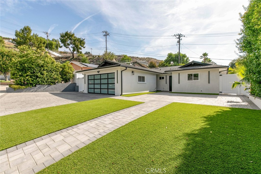 Stunning Remodeled Entertainer’s Home
Welcome to this beautifully remodeled entertainer’s dream home, perched to overlook the breathtaking Santa Clarita mountains. From the moment you arrive, you’ll be captivated by the exceptional curb appeal and custom paver work that extends from the driveway throughout the entire lot, including the spacious backyard.
This home features a 2-car garage, sleek vinyl fencing for added privacy, and a modern exterior with smooth stucco finishes. Inside, you’ll find dual-pane windows and a sliding glass door that bring in natural light and enhance energy efficiency. Enjoy year-round comfort with central A/C and heating.
The recently renovated kitchen and bathrooms are thoughtfully designed with contemporary finishes, offering both style and function. Step outside to the expansive covered patio—perfect for entertaining—with a built-in BBQ, firepit, outdoor refrigerator, and an elevated seating area ideal for soaking in the serene mountain views.
With meticulous attention to detail throughout, this turn-key property is ready to host all your gatherings and celebrations.