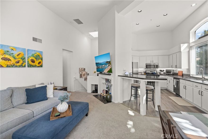 Set within the desirable Cantada community, this home perfectly balances comfort, convenience, and style. Soaring vaulted ceilings and updated windows fill the interior with natural light, creating an inviting, airy atmosphere. The flowing layout connects the dining area and kitchen, with an updated sliding door leading to a private balcony overlooking open space—ideal for a morning coffee or winding down in the evening.



The primary suite offers a generous walk-in closet and a beautifully designed bath with dual sinks, skylight, and modern finishes, while the secondary bedroom features vaulted ceilings and mirrored wardrobes for added versatility.



Recent updates include modern bathroom vanities with designer tile, new kitchen flooring, stainless steel appliances, updated windows, and an upgraded sliding door. The refreshed kitchen is highlighted by updated floors, upgraded cabinetry, and a breakfast bar for casual dining.



With direct garage access, an additional reserved carport, and community amenities including a pool, spa, and BBQ area, this home combines convenience with resort-style living. Its location offers close proximity to Peters Canyon trails along with top-rated schools, parks, dining, and shopping—an incredible opportunity to enjoy the very best of Tustin Ranch.