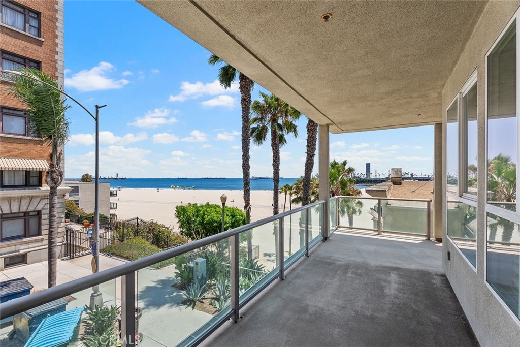 1000 E Ocean Blvd – Coastal Luxury Meets Everyday Comfort. Welcome to beachfront living at its finest. This rare, corner-unit oceanfront condo offers panoramic views, refreshing ocean breezes, and the soothing sound of waves from your wraparound balcony. Turnkey and thoughtfully designed, the spacious 3-bedroom, 2-bath residence blends elegance with coastal charm. Enjoy an open-concept layout with ocean views from the living room, Kitchen and Bedrooms. Gourmet kitchen—featuring a large center island, new appliances, and breakfast bar seating, ideal for entertaining. The sunlit living room boasts oversized south-facing windows, a cozy fireplace, and direct access to the balcony. The generously sized primary suite is a true retreat with large windows, a walk-in designer closet, and a luxurious en suite bath complete with a soaking tub and separate shower. Two additional bedrooms and a full bath are set privately on the opposite side of the unit, along with a dedicated laundry room offering extra storage. Located on the amenity-rich pool level, the home provides convenient access to elevators and building features, including: Two secure parking spaces on the first level, Private storage space, Rooftop lounge and pool with sweeping ocean views, Fully equipped gym, Community pool, game room, and newly renovated recreation room with kitchen and office space. Step outside and stroll directly onto the sand from this impeccably maintained building, and embrace the Southern California beachfront lifestyle you’ve been dreaming of.