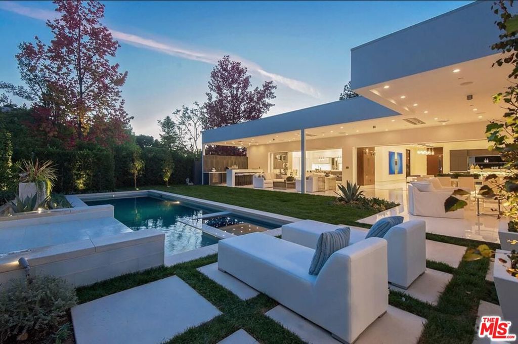 Trousdale contemporary outfitted w/ the highest quality materials, designer finishes, & sophisticated design. The living areas are open to the private yard & covered outdoor living area. There is a large bright chef's kitchen with an oversized center island, Italian crafted cabinetry, & Miele appliances. The master suite is a peaceful sanctuary featuring views of the pool, large fireplace, & a spa-like master bath w/ a private patio & outdoor shower. There are 4 en-suite bedrooms & 7 baths, media room, office, breathtaking bar, 3-car garage, state of the art security, television, & home lighting system.