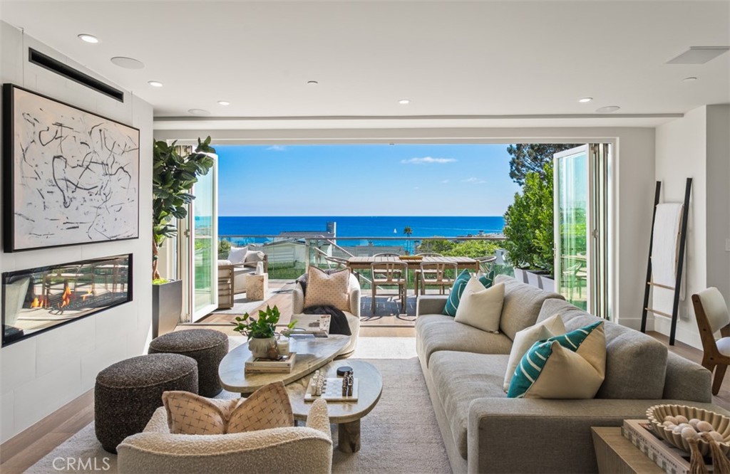 Discover refined coastal living at 1373 North Coast Highway, a striking, newly developed Laguna Beach residence offering approximately ~3,000 square feet of modern luxury with panoramic ocean views and expansive balconies that capture the beauty of the California coastline. Designed for both elegance and convenience, this home features a private elevator, open-concept living space, and high-end finishes throughout. The gourmet Chef's kitchen is equipped with a full suite of Thermador appliances—including a six-burner ProHarmony range, smart refrigerator and freezer, built-in wine fridge, and microdrawer—blending style with cutting-edge technology. Residential amenities include smart home systems, audio/visual enhancements, and multiple view terraces designed for entertaining. The home’s three expansive bedrooms provide comfort and style, with spacious layouts designed for relaxation. The primary suite captures the essence of resort-style living with ocean vistas, a luxurious bath, and private outdoor space. Thoughtful details such as tempered glass railings, copper accents, Jeld-Wen custom doors, and Milgard ultra low-e panels showcase craftsmanship and durability, while a Boral Madera tile roof and James Hardie siding provide lasting strength and design integrity. Parking is effortless with a private single-car garage plus two additional reserved spaces behind a secure LiftMaster gate. Just moments from the world-famous beaches, art galleries, and fine dining, this residence embodies the best of the Laguna Beach lifestyle. 1373 North Coast Highway—where modern design meets timeless coastal luxury.