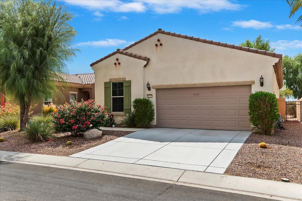Welcome to Sun City Shadow Hills, a premier 55+ active adult community in Indio offering resort-style living. This beautifully maintained 1,321 SF Embark floor plan features 2 bedrooms and 2 baths with a desirable split-bedroom layout for maximum privacy. Newer carpet adds fresh style and comfort throughout, and the home comes complete with washer, dryer, and refrigerator for move-in convenience. The open-concept design offers a spacious great room filled with natural light, seamlessly connecting to the dining area and a modern kitchen featuring granite countertops, stainless steel appliances, white cabinetry, and a center island with breakfast bar seating. Step outside to an oversized low-maintenance backyard with an extended covered patio and stunning mountain views--perfect for relaxing mornings, sunset dinners, or entertaining guests. The home's location near the back gate offers quick and easy community access. Living in Sun City Shadow Hills means enjoying two clubhouses with fitness centers, indoor and outdoor pools, and spas. Golfers can take advantage of the championship 18-hole course and par-3 course, while sports enthusiasts will love the pickleball, tennis, and bocce ball courts. Additional amenities include walking and biking trails, a performing arts theater, on-site dining, a billiards room, a library, arts and crafts studios, and over 60 clubs and social activities. With 24-hour guarded security and a welcoming neighborhood atmosphere, Sun City Shadow Hills offers the perfect combination of recreation, relaxation, and convenience in the Coachella Valley.