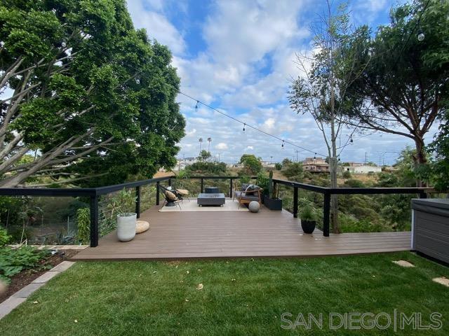 Beautifully renovated home with views, privacy, and half an acre of usable canyon land. The home features paid solar, a saltwater hot tub, EV charger, upgraded electrical panel, whole-house water filtration, and a custom kitchen with 150-year-old reclaimed barn wood accents. Move-in ready with updated bath, fireplace, and shiplap detailing. Never a flip! Enjoy a lush, terraced garden filled with rare tropical plants, fruit trees (orange, avocado, papaya, peach & more), a playground, and a peaceful hidden retreat beneath oak trees. From the primary suite, take in serene canyon views and watch hawks or owls nesting in the majestic fig tree just outside.