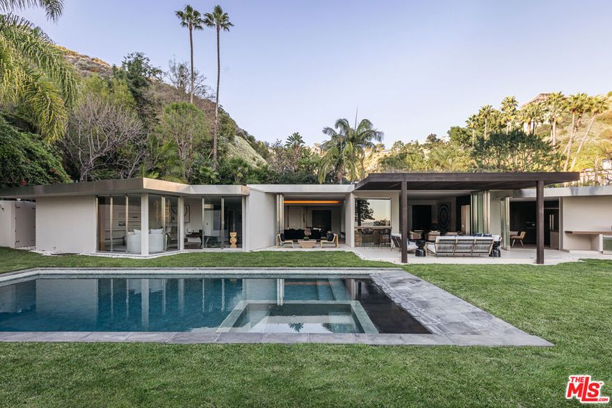 An extraordinary California mid-century modern (1958) reimagined by noted designer Janna Levenstein (2008), the residence has been photographed by Architectural Digest amongst others.  Situated in one of the most coveted, high-wattage enclaves of the Bird Street environs, Rising Glen Road. Large, private and light-filled, 1615 Rising Glen lives on a single level indoors, and out with walls intentionally positioned for major works.  Mid-century architecture rarely comes in a size and scale like this  living in almost 4000sf.  Substantial open spaces are voluminous which blend with the outdoors by way of custom folding walls of steel and glass. All main living spaces open widely to an overwhelmingly large flat lot of over half of one acre - with pool and direct views of the city. Terrazzo floors, cantilevered fireplaces and high coved ceilings remain as originally designed. Graciously sized master suite with walk-in closet, home theater and gourmet European kitchen which pulls in the outdoors seamlessly. Additional amenities include Crestron home automation and 3-car garage with secured gated entry. Extremely private and gated.