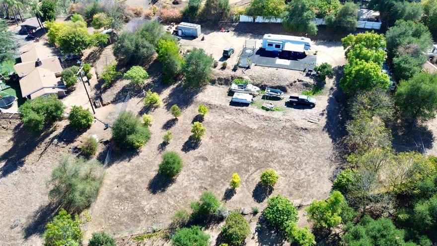 Large .83 of an acre lot.  Level to gentle sloping flag lot with tremendous panoramic views.  Water meter is installed, sewer is available, power is nearby and there is an existing grading rough pad.  Two RVs and 20 ft storage container could convey with the property.  No HOA, no CC&Rs, manufactured home would be ok.  Access to the land is by existing shared driveway with existing neighboring residence.