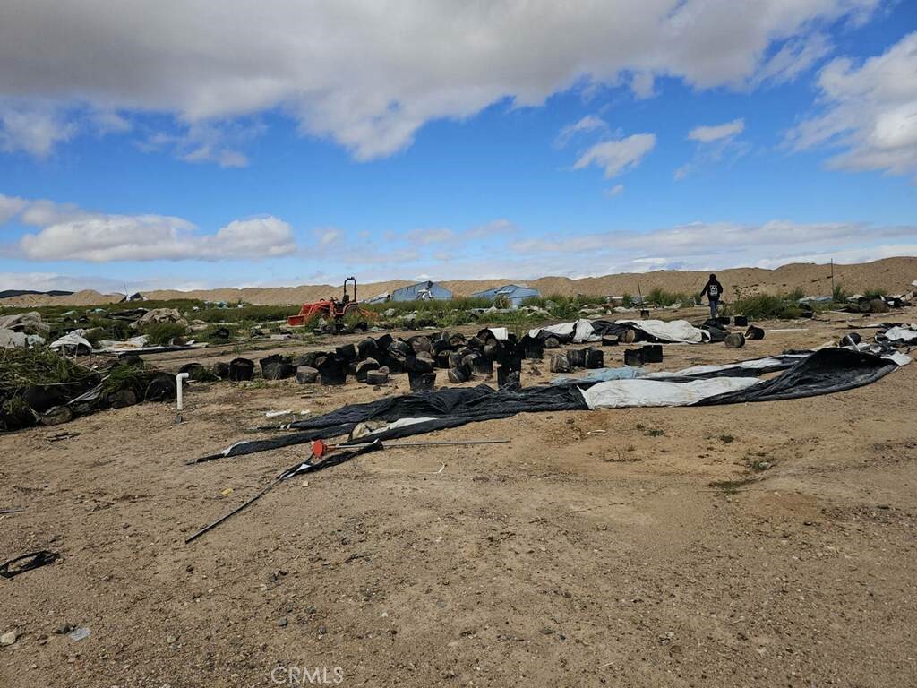 Located approximately 1,280 feet outside the city of Adelanto along the path to Big Bear Skiing, Las Vegas, San Bernardino, and not far from Los Angeles. The Infrastructure development has commenced on this 40-acre parcel, which includes three wells and a septic tank. This land comprises 10 acres of untouched landscape, with the remaining 30 acres being the remnants of a former marijuana cultivation site. The three wells supplied water to 200 greenhouses and other agricultural operations, indicating a substantial water resource. Situated opposite the airport, the property features numerous shipping containers used for importing goods for major retailers such as Amazon, Costco, and Walmart. This extensive acreage presents various possibilities, especially considering its competitive pricing compared to farming land outside our state. It is advisable to act promptly on this opportunity, as signs of regional growth are evident. Prospective investors are encouraged to research the local demographics and market trends to make informed decisions.
The seller is a listing agent