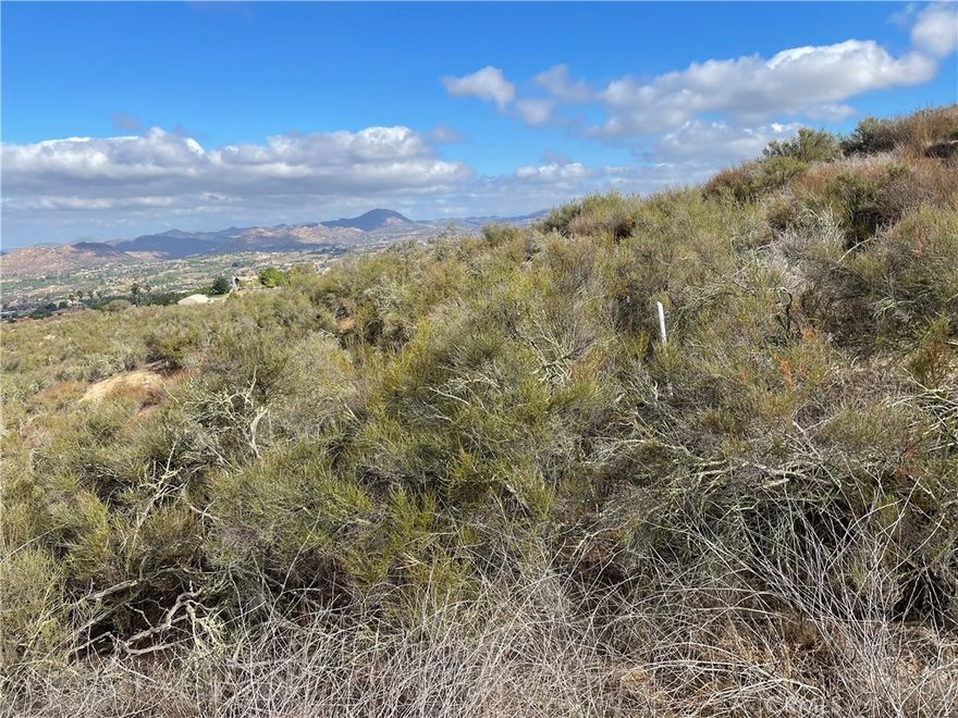 Enjoy privacy and views of Lake Skinner, mountains, and equestrian estates. 4.88 acres in Glenoak Hills, minutes from Temecula wineries.. Water access fronts the property,  Adjacent (2) parcels are also available—contact broker for details. Seller financing may be offered. Rural living close to town.