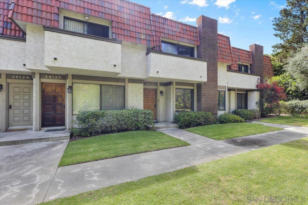 Welcome to this move-in-ready townhome in the highly sought-after Ridgegate community located on South Ridgecove Court. Step inside to a warm and inviting living room featuring new wood laminate flooring, a cozy fireplace, smooth ceilings, and recessed lighting that together create a bright and airy atmosphere. Large windows on either side frame serene views of the lush greenery outside. The updated kitchen boasts elegant Quartz countertops, white cabinetry, and stainless steel appliances, while the adjacent diningliving area—complete with a ceiling fan—opens to a private patio and a detached two-car garage with washer/dryerin-unit laundry hookups. A beautifully renovated powder room completes the first floor. Upstairs, enjoy brand-new carpeting throughout. The spacious primary suite offers two large closets and a fully remodeled en-suite bathroom. Two additional generously sized bedrooms, each with ample closet space, share a stylishly updated full bathroom.