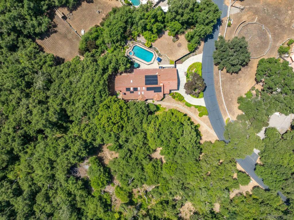 INCENTIVES:RATE BUY-DOWN OR TOWARDS CLOSING COSTS! Beat the summer heat with your own sparkling pool—& keep energy costs down with solar to lower your monthly bill. This home checks all the boxes: solar, gated community, custom PebbleTec pool & spa, 3-car garage, LVP flooring, newer PEX plumbing, skylights, & over 1.3 acres of natural beauty, fully fenced yard, & a layout built for entertaining and everyday comfort. Tucked away in one of West Ramona’s most coveted gated communities, this single-level home rests on 1.32 acres beneath 200-year-old oak trees—offering unmatched peace, privacy, and natural beauty. Thoughtfully upgraded and meticulously maintained, it features newer PEX plumbing, wide-plank LVP flooring, skylights, solar panels, and an airy layout with extra-wide hallways. The spacious floor plan includes a 3-car garage, abundant storage, and a seamless indoor-outdoor flow. The backyard is a true sanctuary: a custom PebbleTec pool & spa with fountain, lush landscaping, & a fully fenced yard ideal for family, pets and entertaining. The property is also a Certified Wildlife Habitat®—officially recognized by the National Wildlife Federation® for supporting pollinators, native plants, and local wildlife. Shady Oaks is a rarely available and highly sought-after enclave in West Ramona—offering the security of a gated entrance, the serenity of nature, & close proximity to hiking destinations like Iron Mountain and Potato Chip Rock. Ideally located between the charm of Ramona and the amenities of Poway, it’s the perfect balance of rural tranquility & suburban convenience