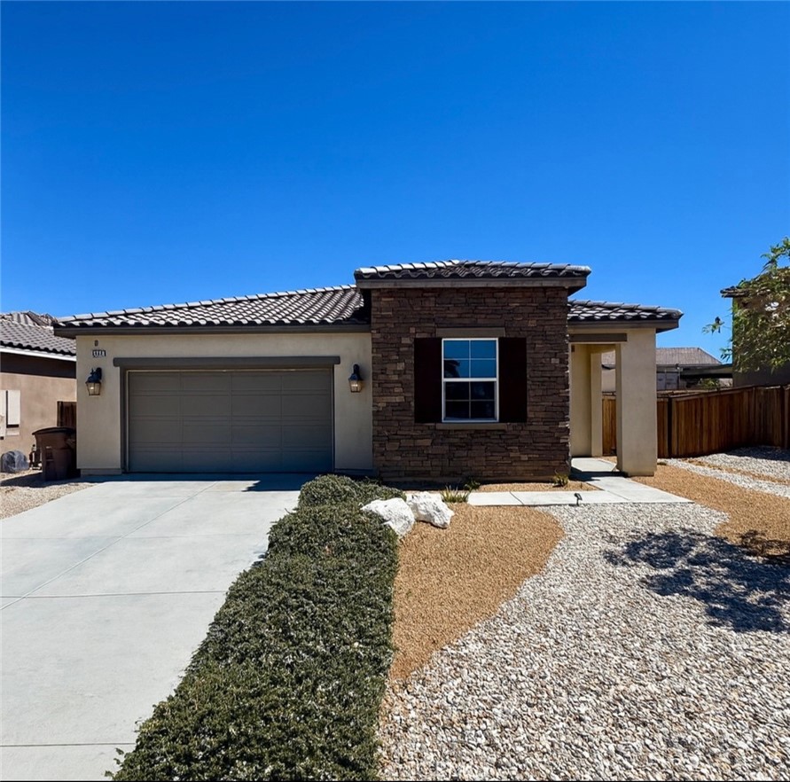 Single story home located in a cul-de-sac in Hesperia. Built in 2018, this residence offers 3 bedrooms and 2 bathrooms with approximately 1,835 square feet of living space. Features include vinyl wood flooring throughout the main areas, an open concept kitchen with generous counter space and cabinetry, and a private primary suite. The home also includes an attached 2 car garage, a tile roof, and exterior stone façade accents. Additional upgrades include a top of the line Rheem tankless hot water heater, a whole house fan, and a Chamberlain garage door opener with smartphone compatibility, all of which stay with the home. The backyard patio was designed extra large with abundant concrete, perfect for creating your own California room. The lot measures approximately 6,882 square feet with low maintenance desert landscaping in the front yard. Conveniently situated near shopping, dining, and community amenities, this property provides ease of access to daily needs. First showings will write this up!