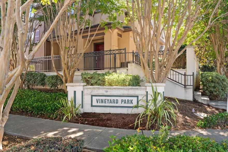 UPDATED CORNER HOME IN PRIVATE COMMUNITY | This tastefully modernized corner townhome delivers stylish convenience, prized centrality, and modern elegance to the exclusive Vineyard Park community. Open, airy interiors filled with natural light boast upgrades like luxury floors, modern fixtures, a glamorous kitchen remodel, and more! Enjoy indoor-outdoor living with multiple gathering rooms, a large secure patio, and no neighbors directly in front. The kitchen showcases quartz countertops, custom Shaker cabinetry, modern full backsplash, and stainless appliances, including a gas range with griddle. Soaring ceilings cover a primary suite fitted with dual vanities and an oversized walk- in closet. Additional highlights include a gas fireplace, surround sound wiring, and an attached, oversized two-car garage. Within one mile of multiple parks, shopping centers, and exceptional schools while also near the library, golf, hiking, commuter routes, and much, much more!