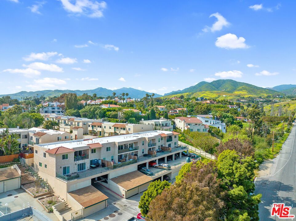 A true find, this impeccably designed condo built in 2021 is in move-in condition and packed with stylish custom upgrades and details. The quiet end-unit offers direct ocean views from a sunny patio. A custom-designed kitchen features Cloe tiling throughout, quartz countertops, and rose-gold accents. In the expansive living/dining area, a reclaimed wood wall provides a chic focal point. The spacious and ultra-private primary suite includes a beautifully updated bathroom with separate dressing room, enormous walk-in closet, and stacked in-unit washer/dryer. The other bedrooms are generously sized, with recessed lighting and large closets. One secondary bedroom features an en-suite bath, and the other enjoys tons of natural light and an ocean view. Plentiful storage throughout the home, plus a detached two-car garage with built-in cabinetry. Residents of the complex enjoy a heated pool and spa, lush landscaping with mature banana and avocado trees, and unbeatable proximity to world-famous Zuma Beach and Point Dume, plus fantastic shopping and restaurants just moments away. Zoned for Malibu's top-rated schools. HOA includes water, trash, & sewer. Close to Pepperdine!