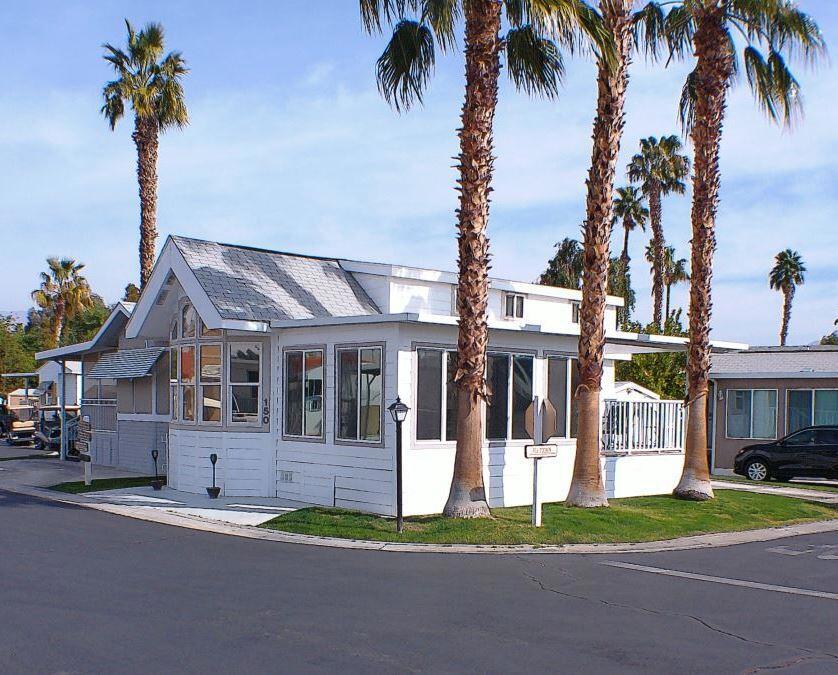 The 2005 Chariot Eagle Park model features custom floor plan. It features. Double loft w/carpet, has two queen size beds perfect for grandchildren play area or added sleeping area. No guest has to sleep on the couch or sofa bed at this address w/total of 3 queen size beds. Built in cabinets in Living Room/Kitchen pantry/Master & Loft add storage area. New interior paint w/Luxury Vinyl Plank Flooring (2021) throughout the living area w/a new (2021) heat pump for AC & heat. New blinds (2022 )w/window tinting. A new 'California room' w/ insulated awning was constructed in early 2022 adding approx 200 sq ft of living area. This magnificent addition includes HVAC with a solid 2x10 deck frame, high end aluminum railing system w/maintenance free Trex decking. This new structure was built w/a new 4 inch insulated aluminum awning that provides sound dampening w/lots of shade, & protection from the wind. Features include a 65 inch high end Vizio TV, new leather sectional, fabric chairs w/accent tables & additional cabinets for storage. This new space changes the use of the whole park model & is an added feature you don't need to build. Step down a few steps to a cozy back patio & storage shed w/electrical & water supply & extra fridge/freezer for those Costco trips.Other features are Gas Range, Fridge, D/W, W/D & Microwave. Great Parking, Weber BBQ & Patio Furniture, Powered Reclining Sectional & reclining sofa. Move in w/your clothes, then relax & enjoy. Quick Possession.