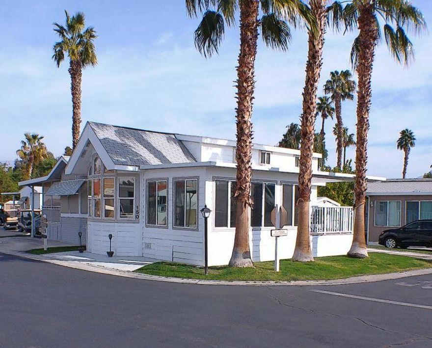 The 2005 Chariot Eagle Park model features custom floor plan. It features. Double loft w/carpet, has two queen size beds perfect for grandchildren play area or added sleeping area.  No guest has to sleep on the couch or sofa bed at this address w/total of 3 queen size beds. Built in cabinets in Living Room/Kitchen pantry/Master & Loft add storage area. New interior paint w/Luxury Vinyl Plank Flooring (2021) throughout the living area w/a new (2021) heat pump for AC & heat.  New blinds (2022 )w/window tinting. A new 'California room' w/ insulated awning was constructed in early 2022 adding approx 200 sq ft of living area.  This magnificent addition includes HVAC with a solid 2x10 deck frame, high end aluminum railing system w/maintenance free Trex decking.  This new structure was built w/a new 4 inch insulated aluminum awning that provides sound dampening w/lots of shade, & protection from the wind.  Features include a 65 inch high end Vizio TV, new leather sectional, fabric chairs w/accent tables & additional cabinets for storage.  This new space changes the use of the whole park model & is an added feature you don't need to build.    Step down a few steps to a cozy back patio & storage shed w/electrical & water supply & extra fridge/freezer for those Costco trips.Other features are Gas Range, Fridge, D/W, W/D & Microwave. Great Parking, Weber BBQ & Patio Furniture, Powered  Reclining Sectional & reclining sofa. Move in w/your clothes, then relax & enjoy. Quick Possession.
