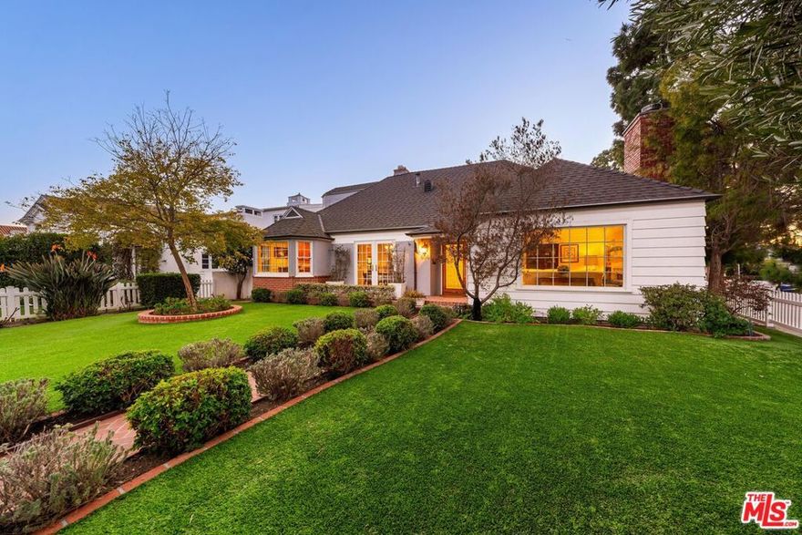 Nestled North of Montana, this enchanting traditional home sits gracefully on a sprawling 10,000+ square-foot corner lot, exuding classic curb appeal behind a charming white picket fence. Offering 3,407 square feet of beautifully designed living space, this residence features 4 bedrooms and 3 bathrooms in the main house, thoughtfully crafted for both comfort and elegance. Upon entry, the formal living room welcomes you with its coffered ceilings, crown moldings, and a cozy fireplace, creating a warm and inviting ambiance. Adjacent is the spacious formal dining room, where French doors open to the outdoors, seamlessly connecting to the kitchen. A chef's delight, the kitchen boasts stainless steel appliances, granite countertops, ample storage, and a sunlit breakfast nook. The nearby family room, complete with a second fireplace, flows effortlessly from the main living spaces, offering the perfect setting for gatherings. The primary suite is a serene retreat, awash in natural light, with French doors leading to the backyard, a walk-in closet, and a spa-like en-suite bathroom. This luxurious space features double vanities, marble finishes, a soaking tub, and a waterfall shower. An additional bedroom and bathroom complete the main floor. Upstairs, you'll find two charming bedrooms and a bathroom, all connected by a patio that overlooks the lush backyard. Additionally, a cozy study, which can serve as a fifth bedroom, adds versatility to the home's layout. Step outside to a private oasis, where a pergola-covered patio, built-in barbecue, and verdant grassy area create the ideal backdrop for outdoor entertaining. Beyond the main home, a detached guest house offers a spacious studio with soaring ceilings, a kitchenette, and a full bathroom perfect for hosting visitors or setting up a dedicated workspace. The property also includes an oversized three-car garage with convenient alley access, blending practicality with style. Located in one of the Westside's most desirable neighborhoods, this home is just a short stroll from Montana Avenue's vibrant shops and restaurants. With its perfect combination of charm, space, and prime location, this property is truly a rare gem.