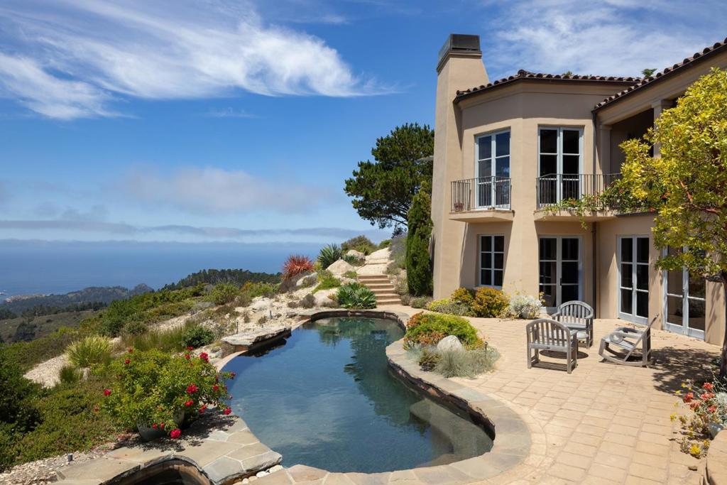 Perched high above the Pacific in the rarely available and highly sought-after gated community of Point Lobos Ridge Estates, this 5-bedroom, 8 bathroom custom home offers sweeping ocean and mountain views that capture the essence of Big Sur within minutes of Carmel-by-the-Sea. Numerous windows and glass doors frame dramatic vistas, and an infinity-edge pool blends seamlessly into the horizon. Designed for luxury living and effortless entertaining, the home features a chef's kitchen, spacious living areas, and private bedroom retreats, all finished with impeccable craftsmanship and high-end materials. Set in the quiet seclusion of Carmel Highlands, this architectural gem combines natural beauty with refined elegance. A rare opportunity to own a legacy property in one of California's most iconic coastal locations.