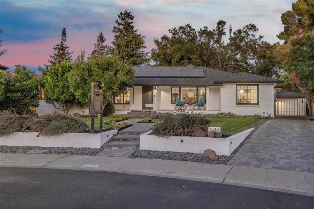 Beautifully updated home with an abundance of space and modern upgrades! Owned Tesla NEM 2.0 11.475 kW solar system and charging station. Paver driveway and automatic gate, covered tile porch, mature greenery, and fruit trees. Inside, enjoy an open living area with hardwood floors, crown molding, recessed lighting, and a stone-faced wood-burning fireplace. The dining room flows seamlessly into the large kitchen with center island, eating bar, gas stovetop, granite and quartz counters, pantry, built-in L seating, and desk area. The spacious primary suite offers hardwood floors, cedar-lined closets, and a luxurious bath with a walk-in tiled shower, dual sinks, and a free-standing soaking tub. Three additional bedrooms feature hardwood floors, crown molding, ceiling fans, and cedar-lined closets, with a stylish hall bath nearby. A versatile enclosed patio room with tile flooring and wood beam ceiling is perfect for an office, gym, or play space. Finished basement of approx. 1,000 sq. ft. (not included in homes square footage). Newly refinished hardwood floors, fresh interior paint, central A/C, and inside laundry. The expansive backyard oasis boasts a large redwood deck, upper and lower lawn areas, walkways, play structure, and mature trees. The oversized 2-car garage with workshop.