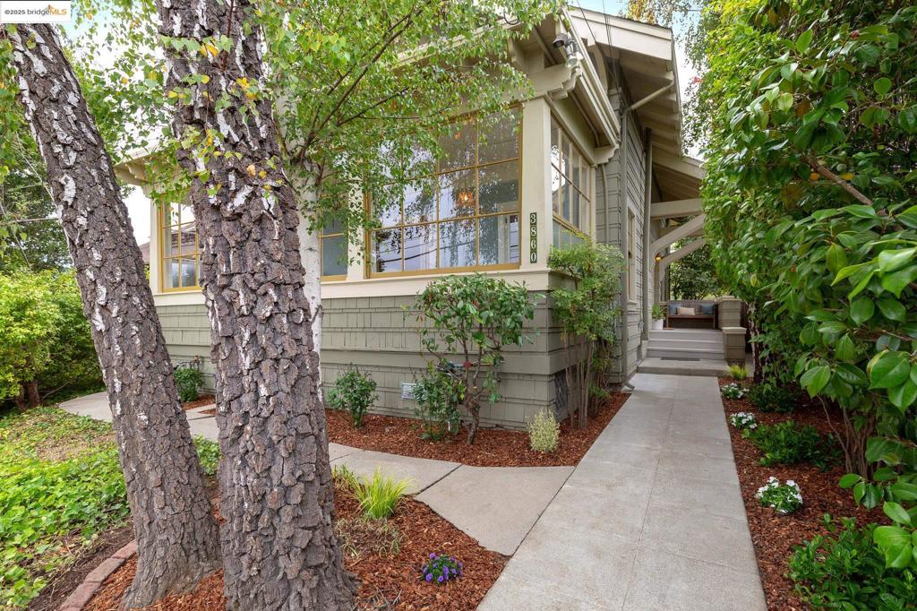 This stately and spacious 1914 Glenview craftsman beautifully combines original detailing with modern amenities. A large updated eat-in kitchen with breakfast nook opens to the big sunny deck, level lawn and landscaped park-like garden with apples and lemons. A perfect setting for al fresco dining, entertaining, play and quiet relaxation. The majestic living room boasts a handsome fireplace with built-ins and opens to a wide sunporch, surrounded by windows. What an ideal space for play, music, exercise or hobbies! There is a powder room next to the grand staircase, which includes the washer and dryer. Upstairs is the large primary bedroom overlooking the landscaped garden with three closets providing ample storage. Across the hall is a second sweet bedroom with a front garden and neighborhood view. There is also a cozy den/office or nursery behind French doors with a partial Bay view. The stylishly renovated primary bath features a tub with shower and skylights. This gracious home has been lovingly cared for including earthquake retrofitting. Glenview offers popular restaurants and shops just three blocks away, with a direct San Francisco express bus nearby. Freeway access is close, as are Grand Ave, Lakeshore Ave & Farmers Market and Montclair Village. A welcoming neighborhood!