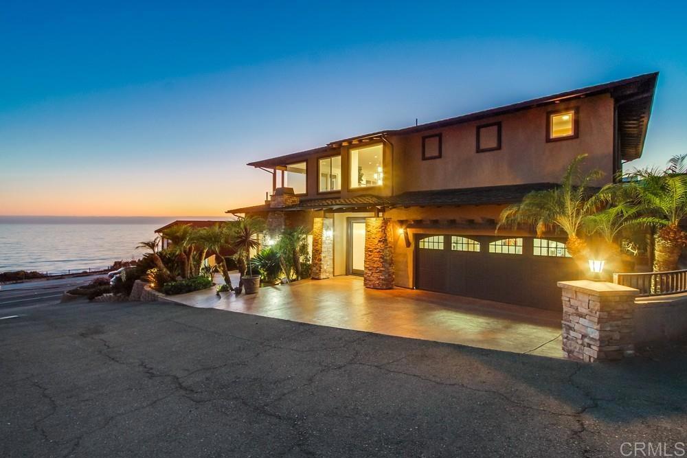 Welcome to refined coastal living in the heart of Cardiff-by-the-Sea, highly sought after Composer District, where sweeping ocean views and timeless design converge in this 3,603-square-foot luxury residence. Thoughtfully crafted for both elegance and functionality, this home features four spacious bedrooms and three beautifully appointed bathrooms, Panoramic Ocean views-offering a balance of comfort, privacy, and sophistication. The heart of the home is the chef-inspired kitchen, outfitted with premium Monogram appliances, dual ovens, and a generous center island—paired with its connected family room that boasts incredible endless views out to the Pacific- perfect for entertaining or creating gourmet meals at home. Multiple side terraces and a spacious rooftop deck capture breathtaking panoramic vistas, offering seamless indoor-outdoor living and unforgettable sunset moments. The primary suite is a spacious private retreat with expansive ocean views, boasting 14-foot vaulted ceilings, a cozy sitting area, an expansive walk-in closet, and a spa-like bath with a jetted tub and a walk-in shower. Additionally, on the main floor there is a grand living room with a vaulted ceiling just off the primary suite equipped with a large fireplace and multiple large windows that face out to the Pacific ocean with breathtaking views, along with two additional bedrooms that share a stylish Jack and Jill bathroom—one of which has a convenient elevator in it for ease and accessibility. Modern upgrades provide a blend of luxury and peace of mind, including three fireplaces, an advanced full-home fire sprinkler system, and a master water-leak detection with auto shut-off sensors. Just steps from the charming shops and restaurants of downtown Cardiff and Encinitas, and a short stroll to iconic Swami’s surf break, this exceptional home invites you to embrace the best of coastal California living. Live the dream—where ocean views, elevated design, and beachside convenience come together effortlessly.