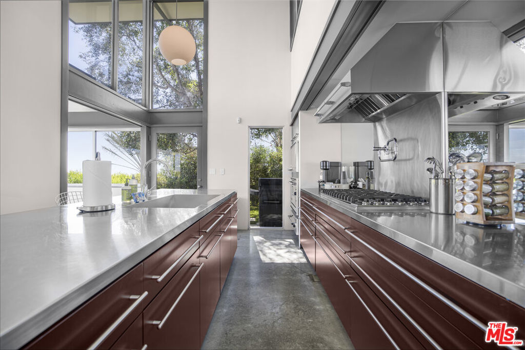 Framed by soaring walls of glass and accented with exposed wood beams, this contemporary residence is bathed in natural light, creating an airy and harmonious atmosphere throughout. The open-concept floor plan flows seamlessly into a chef's kitchen outfitted with a full Viking appliance suiteperfect for elegant entertaining or intimate evenings at home.Outdoors, retreat to your private pool and spa or take in breathtaking panoramic views stretching from Downtown LA to the Pacific Ocean. Multiple lounge areas, including a rooftop deck with near 360 vistas, invite effortless indoor-outdoor livingwhether for sunset cocktails or morning yoga.Upstairs, the primary suite commands sweeping city views and features a Japanese-style soaking tub, open loft office, and direct rooftop access. Three additional bedrooms provide versatility for guests, family, or creative workspace.Additional Highlights:Secure, gated entryDesigner furnishings and organic minimalist dcorJust minutes to the Beverly Hills Hotel, Rodeo Drive, Whole Foods, and moreWhether relocating, renovating, or simply escaping, this home offers a rare opportunity to live in one of Los Angeles' most coveted and inspiring settings.
