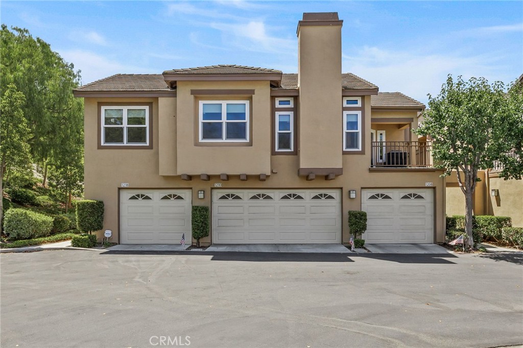 Move-in ready home in the beautiful Summit Court community of Anaheim Hills. This beautiful 2 bedrooms 2 bathrooms Carriage Model is an above the garage end unit with only one shared wall. Located at the end of the cul-de-sac with a finished 1 car extended and finished(epoxy floor) garage with an additional assigned 1 car space carport- very quiet and private. The spacious open floor plan effortlessly connects the living room, dining room, and kitchen, making it perfect for entertaining and family gatherings. Two large bedrooms including a master en suite bathroom and walk-in closet and built-in entertainment center and dresser; both bathroom vanities have upgraded cabinets and granite tops . Ceiling fans in both bedrooms and in dining area. Milgard windows throughout. Designer hardwood flooring throughout main living area. The living area has a cozy fireplace with custom mantle and access to the private balcony with the serene views of Oak Canyon. Beautiful chef’s kitchen with white cabinetry, granite countertops and stainless-steel appliances(refrigerator included) and deep sink. The community offers a club house, pool, fitness center and playground for kids. Located in the heart of Anaheim Hills. This home is within walking distance to parks, hiking, and biking trails, while being conveniently close to shopping, restaurants, and the 241 Toll Road. This home is within the award-winning Orange Unified School District, including Running Springs Elementary, El Rancho Middle, and Canyon High School. Hurry this home will not last long!!