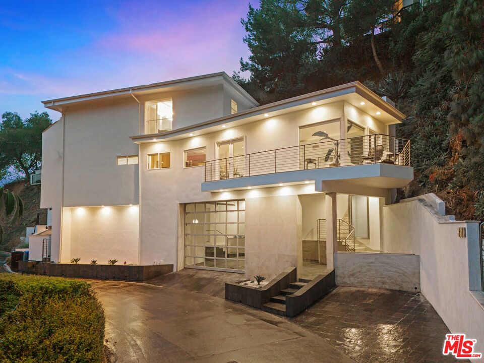 Nestled beneath the Hollywood Sign, this fully reimagined Beachwood Canyon home blends modern luxury with timeless charm. Every inch has been upgraded: new copper plumbing, electrical, roof, windows, and stone flooring throughout. The chef's kitchen and spa-inspired baths showcase designer finishes, while hardwood bedrooms and custom cabinetry add warmth and sophistication. Step outside to your new Brazilian hardwood entertainment deck and take in sweeping canyon and city views, perfect for unforgettable gatherings under the California sky. Recent updates include waterproofed balconies, new HVAC, stainless jacuzzi, fresh paint, and lush landscaping. Located in the heart of illustrious Beachwood Canyon, you're just minutes from the beloved Beachwood Cafe, the historic secret stairs, and Griffith Park trails. With iconic landmarks at your doorstep and luxury at every turn, this home is both a private retreat and an entertainer's dream.