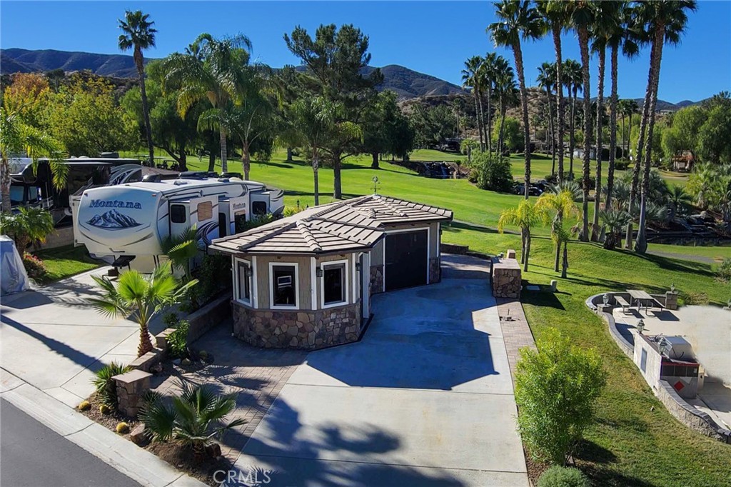Amazing Waterfall Views with Sunset in the Background. Gorgeous Pond and Golf Course Panoramic Backdrop just steps away from Large Fully Screened in Build-Out. Kitchen is Awesome with Granite Counters, Double Oven, 2 Fridges and lots of Storage. Dining room has its own storage Island and walk out doors to RV. Family Room is Massive with Electric Screens, insulated Window Frames, Beverage Cooler and Ceiling Heaters. Build-Out ceilings are large Open Wood Beams with natural colors. Washer/Dryer hookups with Island included. This is a must see property at the Resort. Looking for an RV Resort lot with space and privacy then come check out this perfect location nestled among the foothills of Palomar Mountain, minutes from Temecula Wine Country as well as a convenient location to Palm Springs in just under an hour, 1.5 hrs to San Diego and 1 hr to the beach in Oceanside. Rancho California RV Resort provides amenities such as a 14 hole Executive PAR 3 Golf Course (no fees for owners), 5 Pools/Jacuzzis, Tennis courts, Pickle-ball courts, Dog park, Club house, hiking trails, Horseshoe lawn and onsite grocery market. The resort is guard gated with no age restrictions. Monthly HOA fee includes use of the golf course, amenities, trash pickup at lot, water/sewer and common area maintenance. If you are considering a premier Southern California RV destination, don't miss out on visiting Rancho California RV Resort - Financing Available, schedule a showing today! RV also 4Sale...
