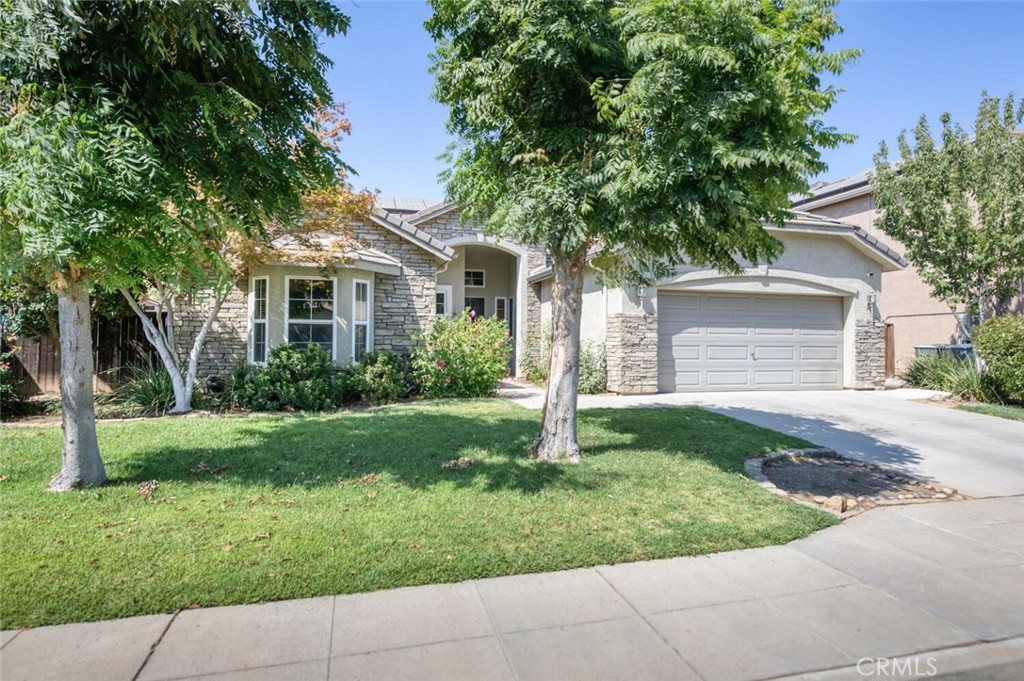 This beautiful 3bd, 2.25ba home offers 2,030sf of living space with solar and excellent curb appeal. The living room blends openness with definition, highlighted by arched openings to the kitchen and casual dining area, plus a separate formal dining room. The kitchen is a true centerpiece with granite counters throughout, including the center island with sink, gas cooktop, stainless appliances, and ample cabinet space. In 2021, the cooktop, oven, microwave, dishwasher, and refrigerator were replaced with energy-efficient models. A desk nook and laundry room with sink add convenience. The primary suite offers patio and pool access plus an ensuite with jetted tub, oversized shower, and dual vanities. The backyard is ready for entertaining with a sparkling pool, spa, and a 2023 outdoor kitchen featuring a built-in grill, refrigerator, mounted TV, fire feature, and covered structure with bar seating. A 2-car garage provides parking and storage. Located in CUSD: Clovis High, Clark, and Red Bank, and close to restaurants, shopping, and a short drive to Fwy 168.