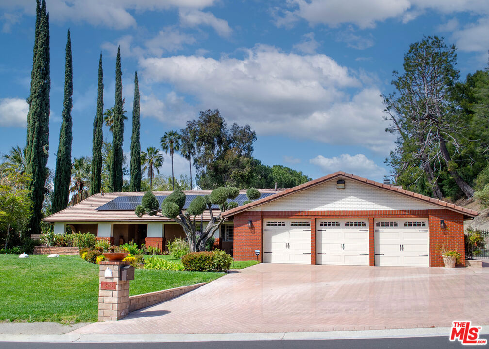 This stunning single-story home in the prestigious Sand Canyon neighborhood offers a rare opportunity to enjoy luxury, comfort, and versatility. Inside, the spacious open-concept layout features rich hardwood floors and a chef's kitchen complete with quartz countertops, a large center island, and premium stainless steel appliances including a Viking Series 5 double oven, Viking hood, and built-in Thermador coffee machine. The living area, equipped with surround sound, opens through French sliding doors to a resort-style backyard with a pebble-bottom pool and slide, built-in BBQ island with Grand Turbo 6-burner grill, outdoor lighting, integrated music system, and a grassy lawn. The home includes five bedrooms and three beautifully updated bathrooms, including a luxurious primary suite with a fireplace, jetted tub, dual vanities, cedar-lined walk-in closet, and French doors to the backyard. Additional features include an oversized three-car garage with extra space for a gym or workshop, an extended paver driveway, three rear horse stables perfect for equestrian use or additional storage, paid solar panels, and sweeping mountain views. Located on a quiet street near Sand Canyon Golf Course, this exceptional lease opportunity combines high-end living with unmatched outdoor amenities.