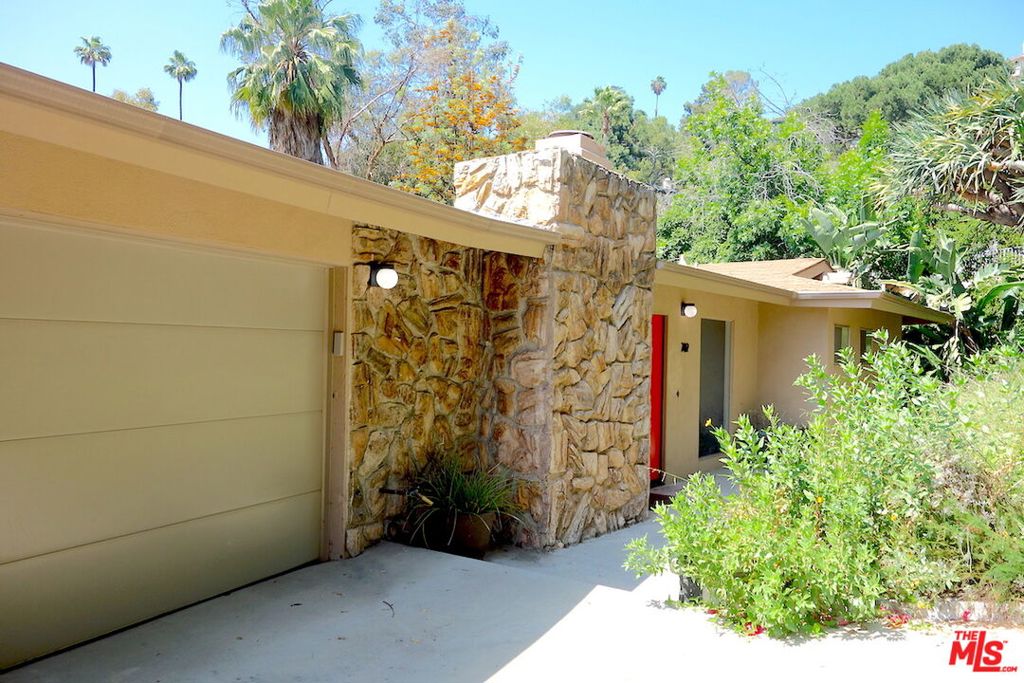 Inspiring Hillside Mid-Century Home with Breathtaking Views. Views, tranquility, architecture. These words will resonate with you from your first glance of this hillside home located in the historic community of Rossmoyne. This renovated mid-century home features majestic mountain views along with picturesque city views. It is inviting and reminiscent of its original midcentury characteristics which have been revived and showcased. Imagine soaking up some sun and enjoying spectacular views during the day and cozying up to a warm fire in the evening. You will be inspired by the vista, nature, and beautiful sunsets from the comfort of your home.This split level, revitalized home is perfect to live and create! New paint, floors, bathroom fixtures, central AC, in-unit laundry, walk-in closets, working fireplace, attached 2-car garage and deck to add comfort to your modern lifestyle. The first level consists of a kitchen, formal dining area, half-bathroom, large living room with views, master bedroom with en suite, walk-in closet and full bathroom. Located in the downstairs level are the second bedroom, family room featuring wet bar, along with access to the expansive deck. Additionally located on this level are the third bedroom and third bathroom, accessible from the hallway. Come live in this peaceful, mid-century home! Be inspired to create your next masterpiece.