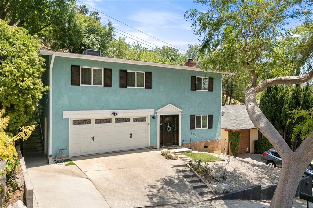 Nestled on a serene, tree-lined cul-de-sac, this delightful two-story traditional home offers the perfect blend of charm, privacy, comfort, and convenience. Minutes away from South Pasadena’s business/shopping district (Mission/Fair Oaks), weekly Farmer’s Market, Arroyo Seco Recreational area (golf, tennis, soccer fields, stables, parks), downtown LA, Old Town Pasadena, and the historic 110 Fwy. Thoughtful updates throughout—including stylish new light fixtures, which enhance the home's warm and inviting ambiance. Step through the front door to discover a spacious bedroom featuring an ensuite bathroom adorned with elegant travertine flooring and updated fixtures. This tranquil retreat offers abundant closet space and a view of the quiet tree-lined street. Upstairs, you’ll discover a spacious kitchen with granite countertops and rich hardwood floors that flow seamlessly into the adjacent dining room—ideal for both everyday living and entertaining. Sliding glass doors off both the dining area and living room open to a peaceful garden patio with sweeping views of the valley and sparkling city lights—perfect for relaxing evenings or hosting guests. The expansive living room is filled with natural light and features treetop views and a cozy fireplace, creating a welcoming atmosphere. The second floor also includes two generously sized bedrooms, each with hardwood floors and ample closet space. The full bath has been tastefully updated with modern fixtures, a travertine floor, and a beautifully tiled shower. Additional highlights include a two-car attached garage with a dedicated laundry area, workbench, and abundant built-in storage. Located in a highly sought after neighborhood on a welcoming, family-friendly street, nestled within the prestigious and award-winning South Pasadena Unified School District. This move-in ready home is a rare opportunity in a community known for its charm and small town vibes with easy access to urban amenities.