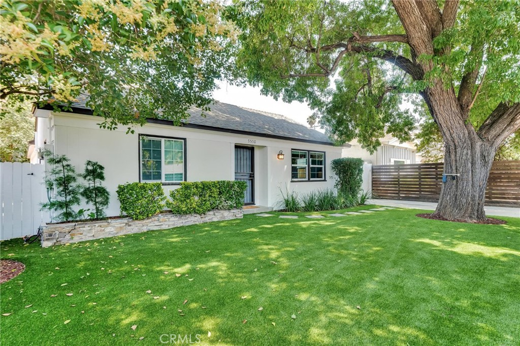 Freshly updated and reimagined mid-century bungalow with detached garage and studio/guesthouse in prime Woodland Hills location! Remodeled and renovated! Main house plus separate studio/guesthouse with bathroom and a garage. Highlights include tri-pane windows, brand new flooring, fresh paint, brand new wall mounted AC system with new ducts, all new appliances, and new landscaping throughout! Master bedroom beautifully updated, with huge walk-in closet. New, stylish wood fencing around the property provides security and privacy. Ample room for pets. Updated landscaping, front and back, makes use of towering shade trees, lush artificial/no water turf, and well landscaped low maintenance garden that creates a relaxing environment to enjoy or entertain outdoors. Enter into an elegant living room with recessed lighting which flows into the kitchen with sunny breakfast nook with wainscoting. The kitchen has been redone with brand new white cabinets, white quartz counters, tumbled marble backsplash, farmhouse sink and new stainless-steel appliances. Down the hallway is an updated full bath, with white quartz vanity and dual shower heads and two bedrooms, and new, central, stacking washer and dryer. Bronze fixtures and hardware throughout. The large, enclosed, lanai/master bedroom is equipped with a brand-new split system AC unit, oversized walk-in closet space, with direct access to the large backyard. The detached studio/guesthouse with bathroom includes a garage with a new garage door. The airy studio/guesthouse has cathedral ceilings, new skylights, new split system AC, and decorative white wainscotting. It includes a brand-new kitchen area with all new appliances, full bath, and ample room for a bedroom area, living area, and space for dining, as well as direct access to the attached garage space and private shaded outdoor patio. There is a 2nd set of laundry hookups in the garage. Wonderfully situated near shopping, dining, entertainment, recreation, great schools including Hale and El Camino, the Westfield Topanga Mall and Village, Calabasas Commons, Warner Center, and so much more!