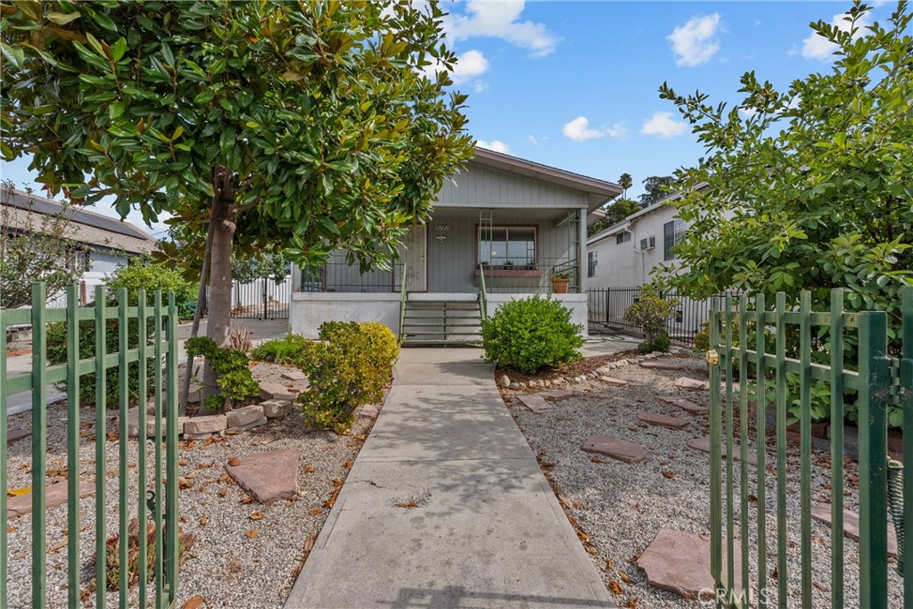 Opportunity is Knocking! Outstanding Highland Park property featuring 2 homes on 1 lot, Zoned LARD2. This is the one you have been waiting for! Family owned for almost 50 years! The front house draws you in with the charming raised covered front porch providing ideal views of the neighborhood. Step back in time to this meticulously maintained home complimented by old and new charm. The stunning hardwood floors and bold baseboards throughout are impressive, crown molding and curved ceiling with ceiling fan in the living room are inviting features. The dining room boasts a functional built in buffet with lights and glass fronts, quite the statement and period piece. The decorative glass doors leading to the kitchen open and close giving a different feel to each room. The kitchen has been updated and your solid surface counters with seamless sink are in impeccable condition and the amount of cabinet space is perfect. The remodeled hall bath was designed with a large jetted tub with detachable wand, the primary is generous in size and allows for a large walk in closet, both bedrooms have ceiling fans and mirrored wardrobe closets. Other improvements include a tankless water heater, copper plumbing, most windows have been updated, electrical panel and roof (approx 11 years old)
The Back House - Super cute 1+1 with kitchen and living room! Wow, what incredible space. Upgrades and features of this home include roof (approx 11 years old), bamboo floors in living room, plush berber carpeting in the bedroom, kitchen with cook top, fridge and sink. 2 split unit air conditioners, copper plumbing, updated windows, ceiling fans and paneled doors. Bathroom with tiled floors and a walk in shower.
This completely fenced and gated yard is designed to accommodate multiple cars, has incredible fig and Meyer lemon trees, storage areas, outside laundry cabinet, the second home has its own electric and gas meter, water is shared. A must see to appreciate the love and care that this home has received!