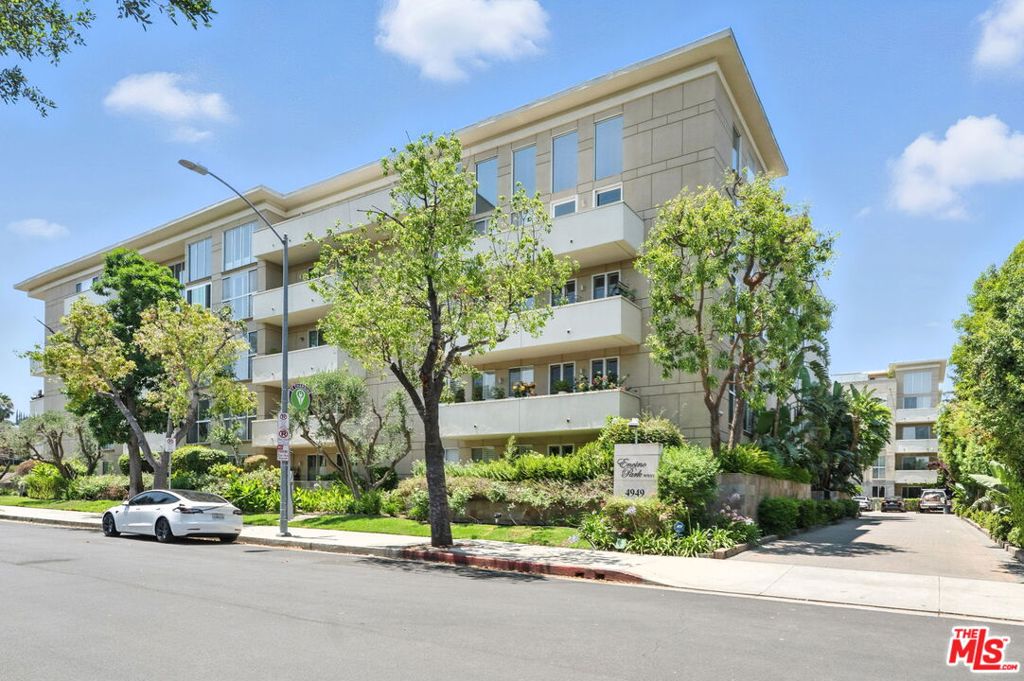 Welcome to Exclusive Encino Park West, a premier full service building located directly across from the beloved Encino Park. This elegant single-level residence offers luxury living in one of Encino's most sought-after buildings. Just moments from Ventura Boulevard and Encino Charter Elementary, this full-service complex provides the ultimate in convenience, security, and lifestyle amenities.Step inside through double doors into a spacious foyer that leads to an expansive open-concept living and dining area, complete with a built-in buffet, decorative fireplace ideal for comfortable day to day relaxation and easy entertaining. The adjacent light filled remodeled kitchen features a cozy breakfast bar with serene pool views, stainless appliances and stackable washer/dryer for added convenience. The private bedroom wing features an expansive primary ensuite retreat, featuring two large walk-in closets, a seated vanity, dressing area, and spa-like bath with a soaking tub & large walk-in shower. A spacious secondary bedroom with its own walk-in closet completes the sleeping quarters. Residents enjoy the peace of mind and prestige of 24/7 front desk concierge, doorman service and comprehensive security camera surveillance. Community amenities include a resort-style pool & spa, fully equipped fitness center with sauna, meeting room/library and card room with full kitchen. HOA inclusions: cable, internet, water, trash, earthquake insurance and property management. Just minutes from boutique shopping, upscale dining and easy access to the Westside and LAX
