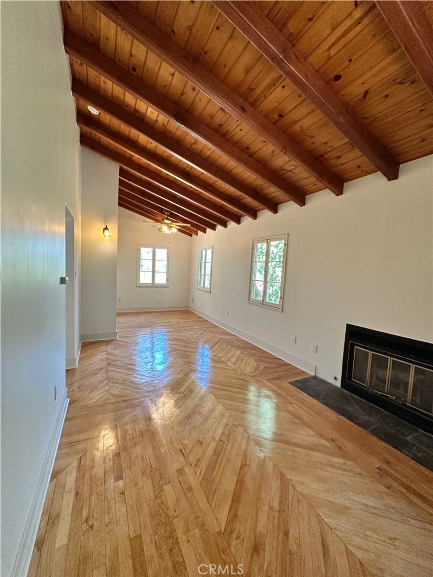 EXPERIENCE SERENE HILLSIDE LIVING IN TARZANA...Escape to this charming, secluded 1-bedroom, 1-bath guest house nestled in the tranquil hillside of a gated Tarzana estate. Park in your dedicated space in the driveway and head up the stairway and along the brick path to your own 600 sq. ft. private retreat.  Step through the stained-glass front door into a warm and inviting living space featuring wood-beamed ceilings, hardwood floors, and a cozy fireplace. The open layout offers a comfortable living room, dining area, and a versatile nook perfect for a desk or reading corner. French windows throughout fill the space with natural light and invite cool hillside breezes.  The bedroom includes a wall heater and A/C unit for year-round comfort. The full bathroom offers a tub/shower combination and linen storage, while a convenient coat closet provides extra space. The well-appointed kitchen, complete with a refrigerator and stove, opens to a back deck with stairs leading to a fenced yard featuring stone pavers—perfect for relaxing or entertaining.  The estate’s beautiful water features create a peaceful, spa-like ambiance. Additional highlights include a washer and dryer located on the side of the main house, utilities included and partial valley views that complete this serene hillside hideaway.