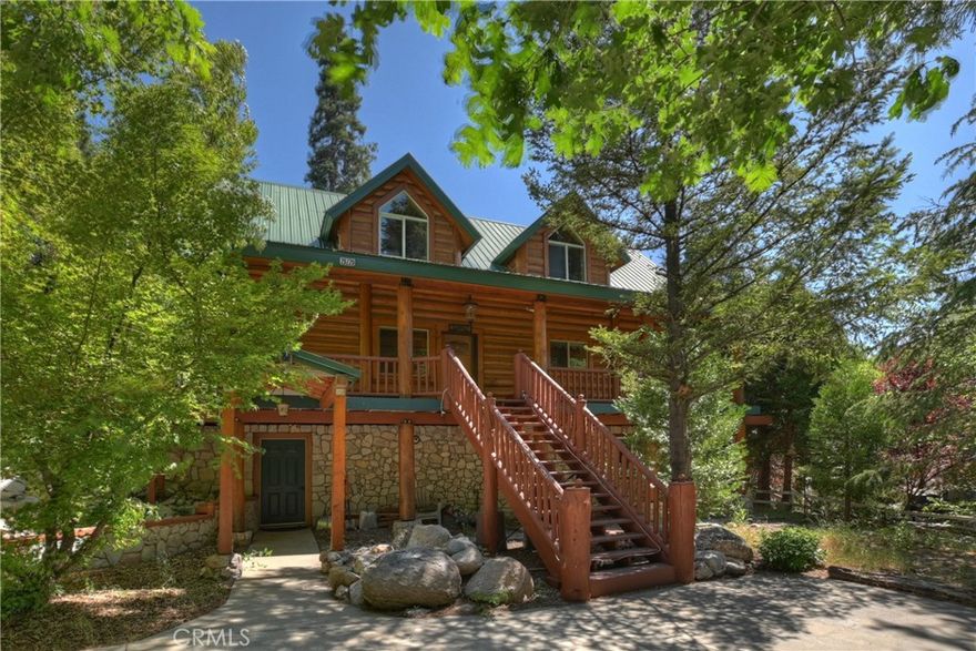 Step into mountain charm with this enchanting Lake Arrowhead real log home with level entry, offered fully furnished and ready for immediate enjoyment or as a perfect Airbnb investment property! Perfectly nestled in a beautiful, park-like treed setting. From the moment you arrive, the inviting expansive front porch and wrap-around deck promise countless moments of relaxation and entertaining under the pines. Inside, you’ll be greeted by a warm and open living room featuring vaulted ceilings and a stunning wall of windows that seamlessly brings the breathtaking mountain surroundings indoors. A cozy fireplace, paired with the open-concept dining area and kitchen, creates the perfect space for gatherings, holidays, or tranquil evenings in. This spacious home offers four bedrooms and two full bathrooms, with two bedrooms and a full bath on the main level, two more bedrooms, a full bath, and a family room on the lower level, as well as a charming loft which can serve as a game room or fifth bedroom on the top floor—each room offering serene views of the surrounding forest. Tons of off-street parking and even additional room to store your boat or trailer. Located just minutes from all the year-round attractions and amenities of Lake Arrowhead, this home is a rare blend of rustic elegance and modern comfort. Whether you’re looking for a full-time residence, vacation getaway, or investment opportunity, this log cabin is truly a mountain escape worth discovering.