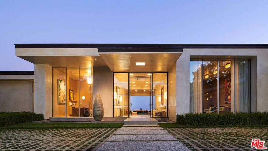 Exceptional, contemporary masterpiece located on one of the most desirable streets in Los Angeles. Reimagined and designed by the acclaimed Studio Shamsiri, the four year remodel invites you to step through the doors and into a meticulously restored Riviera retreat. Captivating views and contemporary refinements collide in this lavish, European styled gem, where each finish builds elegantly upon the next. This 5 bedroom, 6 bath home was designed for distinction, combining expert craftsmanship with an upscale eclectic aesthetic. With high ceilings and beautifully drawn light throughout, the residence boasts an opulent reception room, formal dining area, stylish study and detached studio. Additional features include a grand primary suite with its own poolside veranda, separate guest quarters, stately kitchen, plush media room, and 3-car garage. Privately set back from the street in the illustrious Trousdale Estates, this home is both a place to escape and reconnect as the surrounding city comes to life with bustling boutiques, epicurean delights and world-class entertainment. With impressive views, inspired design, and a serenely secluded location with gated access, this home offers a truly bespoke living opportunity.
