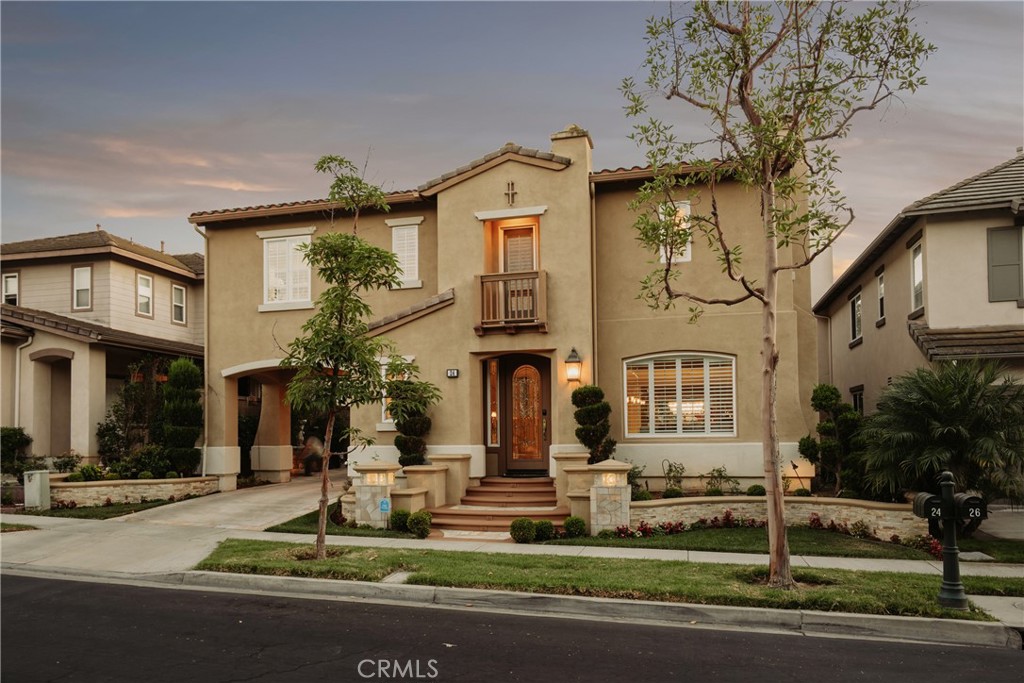 Gorgeous Home in the highly sought after 24-hr GUARD GATED community of NorthPark! As you enter the home, you will love the inviting open floorplan featuring soaring ceilings, hardwood flooring throughout, and lots of natural light. The recently remodeled CHEF'S KITCHEN is bright and airy, featuring a sit up center island, white cabinets, full backsplash, Quartz countertops, Viking stainless appliances, and a separate built in breakfast nook with table. The open kitchen overlooks the Gorgeous Great Room which features built-in media cabinets, a cozy fireplace with beverage cooler and direct access to your private backyard oasis. Step outside to discover the Professionally designed backyard with patio cover, built-in barbeque with cooking warmer, sit-up dining counter area, fire pit manicured softscape/hardscape with grass, flowers and fruit trees. With low HOA and Mello Roos, residents can indulge in the community's amenities including 5 pools, tennis courts, walking trails, and direct access to the acclaimed Hicks Canyon Elementary School. Conveniently located within walking distance to Orchard Hills Shopping Center, which includes Pavilions, Wells Fargo, and many dining options. Zoned for California Distinguished Tustin Unified Schools.