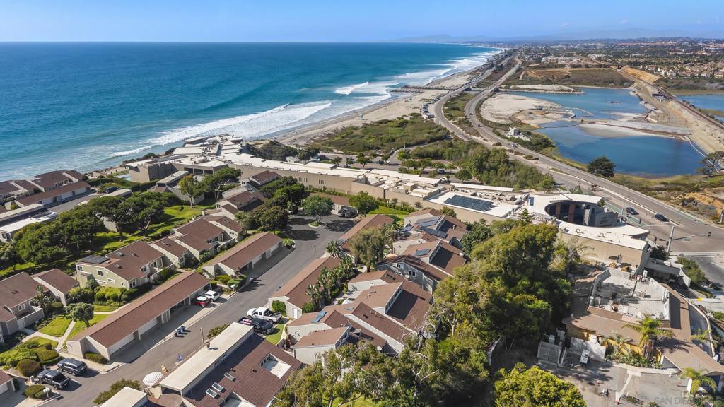 Welcome to beach living at its finest in the coveted, gated Seabluffe community. This split-level 3BD/2BA + loft retreat offers a light-filled layout with a peek-a-boo ocean view, plus a desirable south-facing, end-unit position overlooking the greenbelt for ultimate privacy and tranquility. Unlike many neighboring units, this home feels especially open, with its own “front lawn” and corner location that gives it an airy, uncluttered vibe. Days here feel like a getaway—stroll down the private beach stairs, unwind in one of two heated saltwater pools and jacuzzis, or pick up a game on the pickleball and tennis courts. A detached two-car garage adds convenience, while the lush grounds and serene setting make every moment feel like you’re on permanent vacation. Leucadia restaurants, coffee spots, and shops are just a short walk away—and with weekly rentals permitted, you can keep this as your personal escape or reap the rewards of a lucrative vacation rental.