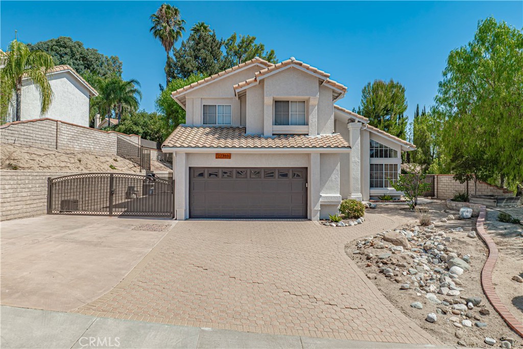 Home Is Where the Heart Is with this gorgeous Castaic pool home. Situated on a quiet cul-de-sac in the North Bluffs neighborhood, this beautiful 4-bedroom, 2.5-bath home offers comfort, style, and incredible amenities. Step inside to soaring ceilings, warm wood flooring, and raised panel doors that add elegance throughout. The spacious floor plan features a separate dining area plus an inviting eat-in kitchen with a breakfast bar, newly updated cabinetry, newer appliances, and granite countertops, perfect for gatherings and everyday living. Upstairs, the huge primary suite boasts a balcony with serene mountain views, creating the perfect spot to unwind and relax. The backyard is an entertainer’s dream—featuring a sparkling pool and spa surrounded by natural rock accents, a relaxing patio area, and plenty of space to lounge or dine al fresco. With approximately 14 feet by 38 feet of gated RV parking, there’s plenty of room for all your recreational toys. Enjoy no HOA or Mello-Roos, and take advantage of the home’s ideal location close to top-rated schools, parks, shopping, freeway access, the Castaic Lake Recreation Area, and scenic hiking trails. This is the perfect combination of privacy, convenience, and resort-style living, and ready for you to call home!
