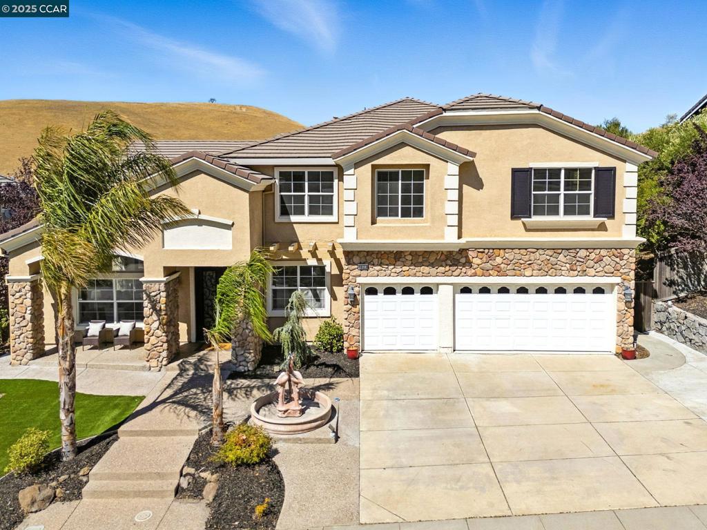 Spacious & updated "Belvedere" model in Peacock Creek at Oakhurst Country Club situated on a premium view lot backing to open space & overlooking sweeping views of oak dotted hills & canyons! This home features 5 bedrooms, 3.5 baths plus downstairs den & upstairs bonus room. Den/home office + one of the bedrooms & full updated bath are on the first level. Updated gourmet kitchen boasts slab quartz counters and island with breakfast bar seating, new chef's grade stainless appliances including built-in refrigerator with wine refrigerator, an abundance of cabinets and stunning two way fireplace with stacked stone! Enormous family room shares 2-way fireplace and includes full walk around bar & custom built-in media cabinet! Huge primary bedroom features double door entry with balcony overlooking hills & valley! Updated primary bath offers dual sinks/vanities, oversized stall shower with floor to ceiling tile surround and separate jetted tub plus two walk-in closets with organizers. Private low maintenance lot with nature fencing allows yard to blend into open space! Custom stamped patio area & walkways, covered patio area plus gazebo, observation deck, custom BBQ island & outdoor fireplace! This home truly has it all! Views: Downtown, Ridge