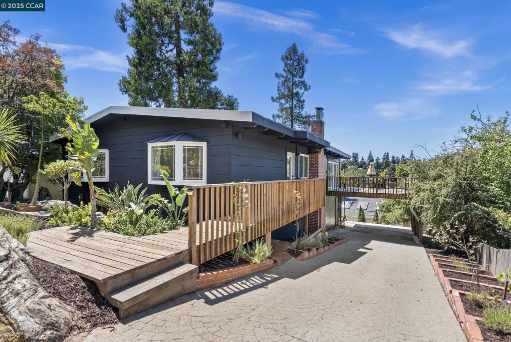Beautifully updated and ideally situated in coveted Montclair, this versatile 4-bed, 3-bath home offers flexible living and breathtaking views. Currently configured as a 3BD/2BA main home plus a separate 1BD/1BA in-law apartment with its own entrance and parking. Easily convertible back to a single-family layout. Set in a gorgeous natural setting, the home enjoys sweeping hillside views, with glimpses of San Francisco, Salesforce Tower, City lights and the Bay. The main level features an open floor plan, remodeled kitchen, two updated baths, and new floor-to-ceiling patio doors that open to a newer 400 sqft view deck—perfect for indoor-outdoor living. The lower unit includes its own stunning kitchen, private deck, and stylish bath. Extensive upgrades throughout: Newer energy-efficient furnace with Nest thermostats, full electrical rewire and panel, new flooring, interior/exterior paint, updated doors/windows, professional landscaping, An ideal home for multigenerational living, rental income, or easily reuniting into one expansive residence. A rare opportunity in one of Oakland’s most scenic and desirable locations. Though it feels peaceful, private, and completely removed from the city, you're literally just minutes from Montclair Village. This property will not disappoint!