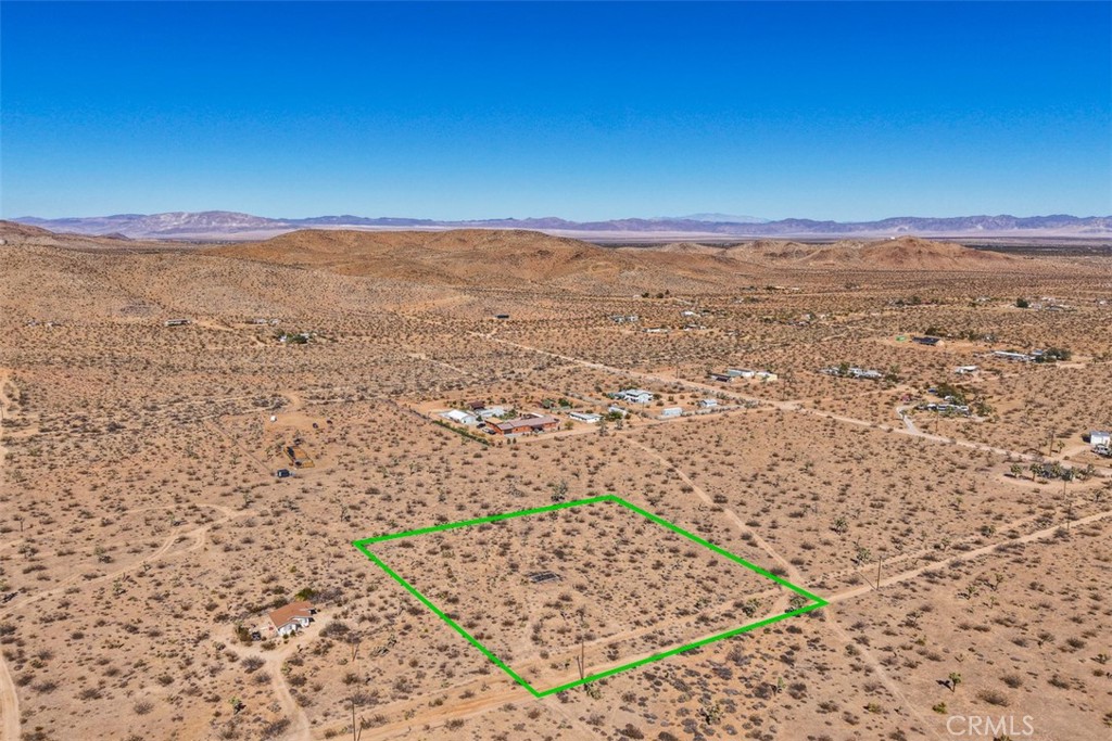 This flat, buildable 2.5-acre lot in the highly desirable Yucca Mesa area of Yucca Valley is the perfect blank canvas for your custom desert home, vacation retreat, or investment property. Located in a peaceful, well-established neighborhood, it offers water and power at the street—a rare find in the Hi-Desert. Enjoy stunning mountain views, breathtaking sunrises and sunsets, and easy access to outdoor adventures like hiking, rock climbing, and stargazing at Joshua Tree National Park. Just 5 minutes from Yucca Mesa Elementary and 10 minutes to both Downtown Yucca Valley and Joshua Tree, this property combines quiet desert living with everyday convenience. Address is fictitious for location purposes; buyer to verify all utilities, zoning, and buildability. Priced aggressively and ready for your vision—seller will consider seller financing with accepted terms.