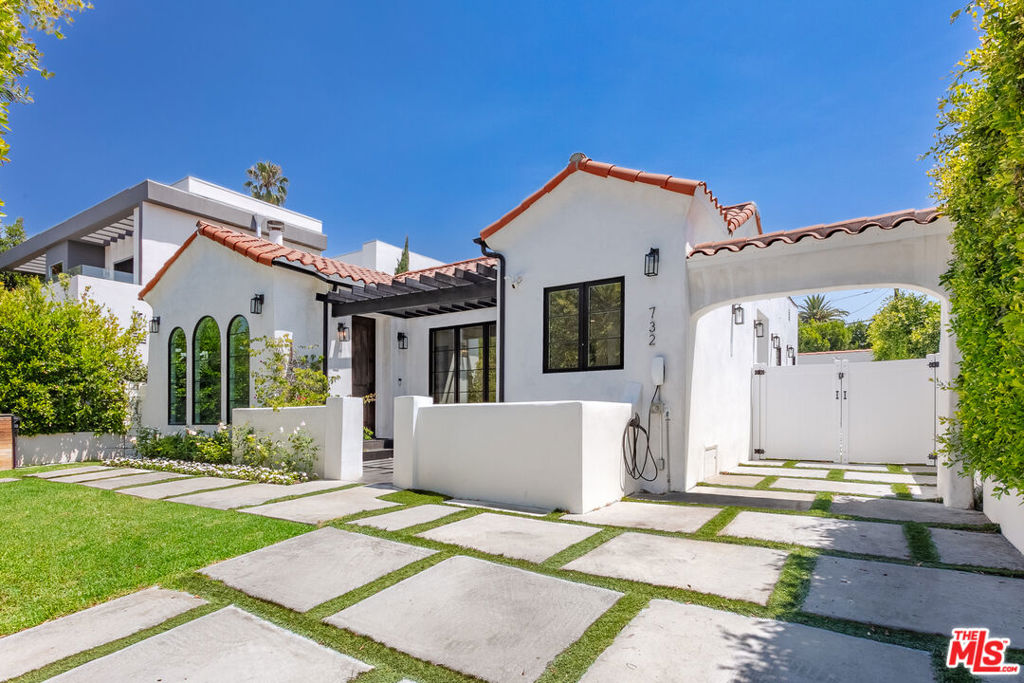 This exceptional home blends space, style, and security with 5BD/4BA, including four bedrooms in the main structure. Behind a gated driveway with secure parking, the light-filled open floor plan showcases soaring ceilings, designer finishes, and a chef's kitchen with oversized island, premium appliances, and seamless flow to dining and living areas that are perfect for entertaining or everyday comfort. The private primary suite offers a spa-inspired bath and dual walk-in closets, while additional bedrooms are generously sized, making them ideal for families, guests, home offices, or creative studios. A newer detached ADU, completed in 2023, adds endless possibilities for visitors, potential income, or work-from-home needs. The backyard is a highlighted by a sparkling pool featuring a Baja shelf and in-pool umbrella space, shaded cabana, yard space, and an outdoor shower. Recent upgrades, within the last five years, include the pool, paid-off solar system, home battery backup, and natural gas generator, delivering both efficiency and peace of mind during power outages. Additional highlights include electric car charging, whole-home water softener, mechanical pool cover, and ample storage. Centrally located near some of the city's best shops and restaurants, with quick access to studios, entertainment hubs, and vibrant nightlife.